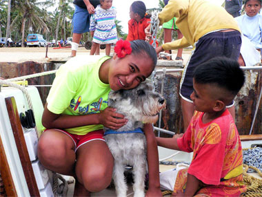 Aitutaki Kids enjoying the only dog on the island